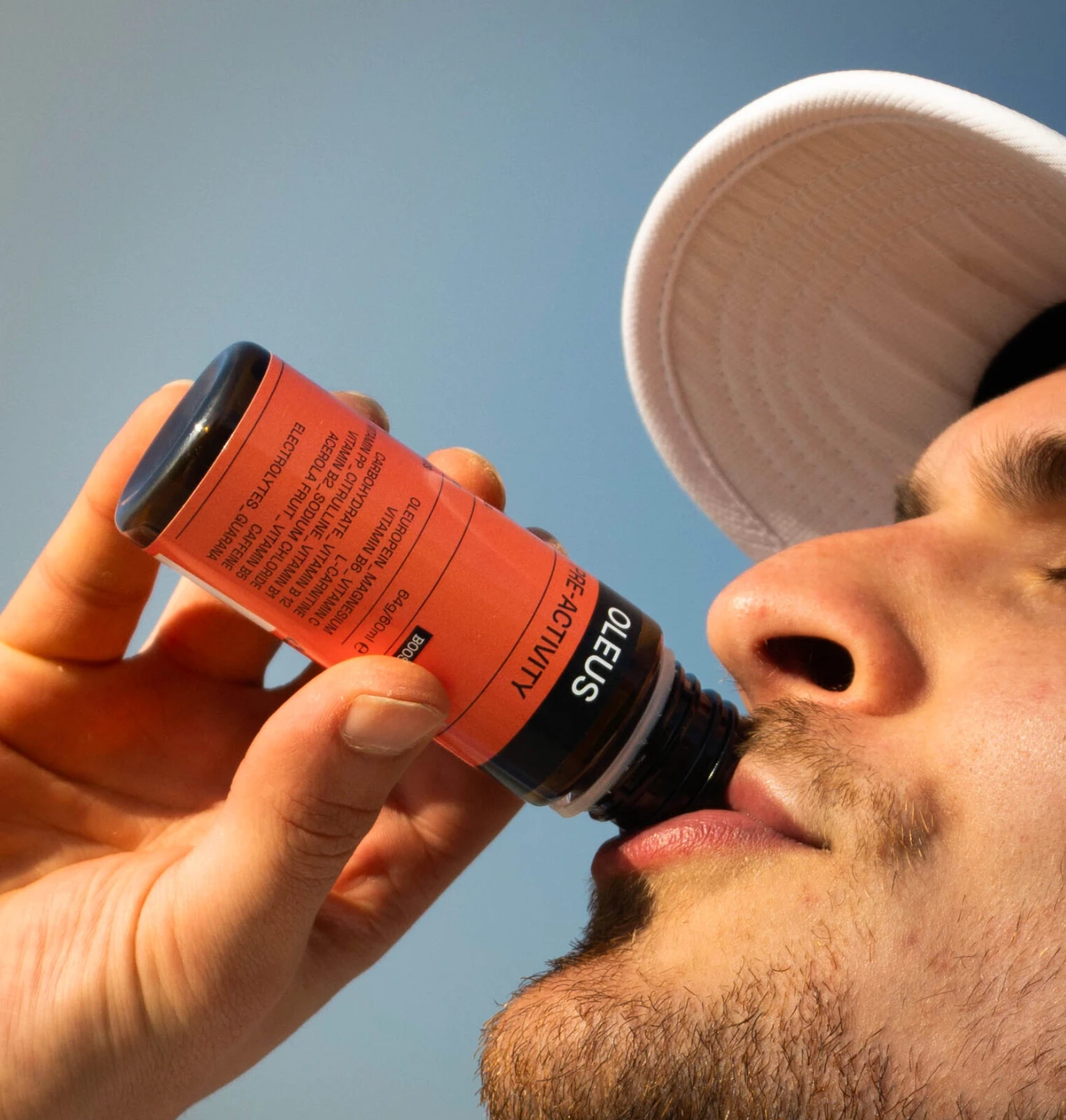 A cyclist drinking an OLEUS shot