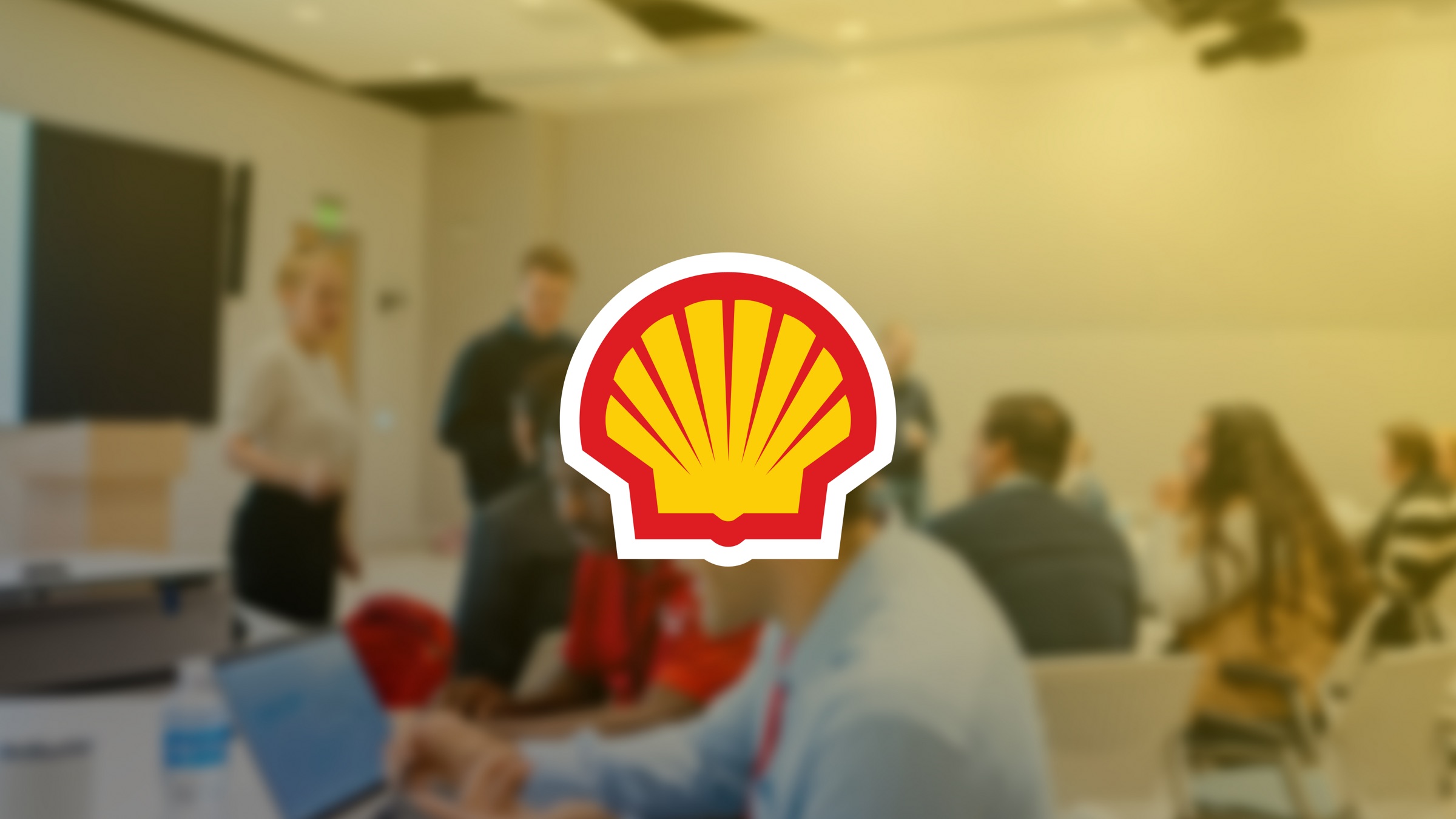 Shell logo over a team workshop